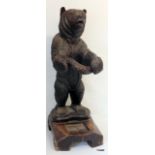A carved Black Forest umbrella stand in the form of a standing bear, 84cm x 31cm x 39 cm