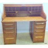 An oak tambour fronted pedestal writing desk 116h x 127w x 78d