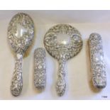 A silver 4 piece vanity set