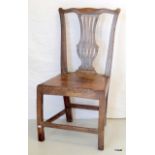 An early 19th century oak hall chair with Lyre back