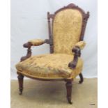 A Victorian mahogany carved framed nursing chair