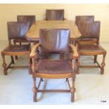 A James Philips and Sons Bristol medium oak draw leaf dining table and 6 leather and studded