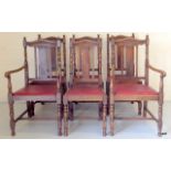 A set of 6 oak carved backed dining chairs to include 2 carvers 77cm high