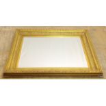A large ornate bevelled edge wall mirror in gilt frame