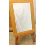 A light oak mirror on easel stand 23cm x 61cm