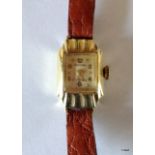 A ladies 14ct gold watch with leather strap