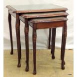 A nest of 3 leather topped tables on carved cabriole legs h54 x w54 x d42