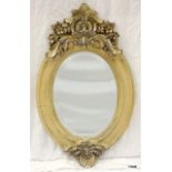 An ornate oval French style mirror, 71cm x 45cm