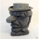 A lead snuff pot depicting a comical face