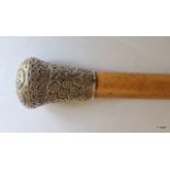 A large antique Indian/ Burmese silver topped Malacca walking cane
