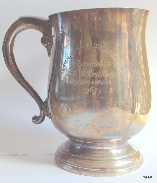 A silver drinking tankard with some engraving