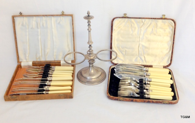 A silver plated condiment stand and two cased boxes of flatware