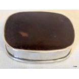 A silver and tortoise shell pill box