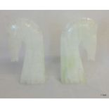 A pair of white marble bookends in the form of horses, 17cm tall