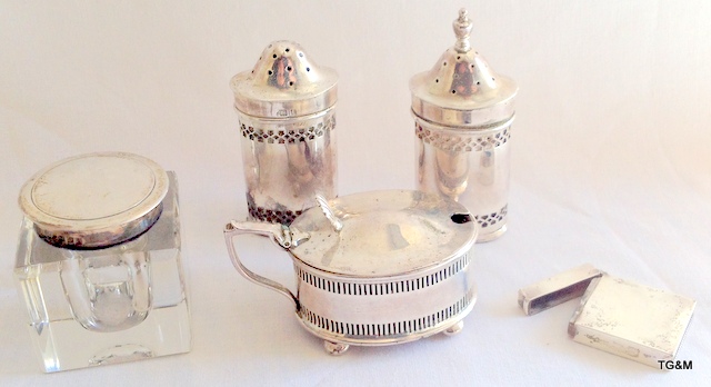 Silver salt and pepper shakers; silver mustard pot; silver topped inkwell; and a vesta case