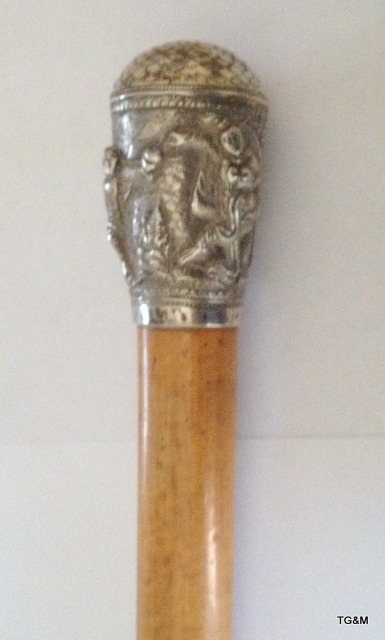 An antique Indian/ Burmese silver topped Malacca walking cane