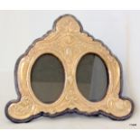 A silver ornate double photo frame