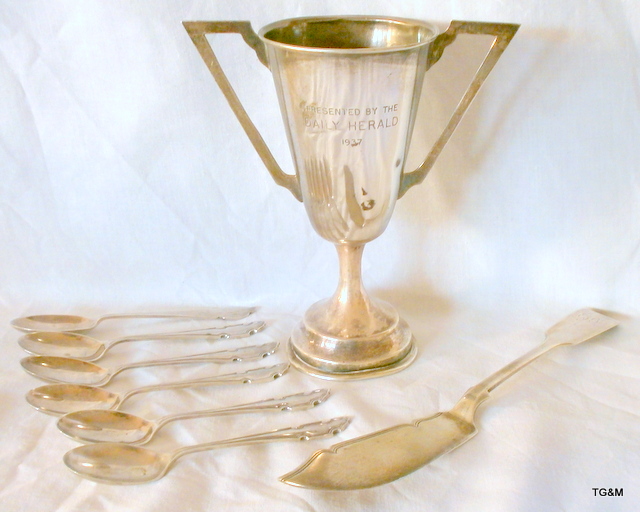 An Art deco silver trophy cup to Daily Herald 1937, a silver fish slice and silver spoons