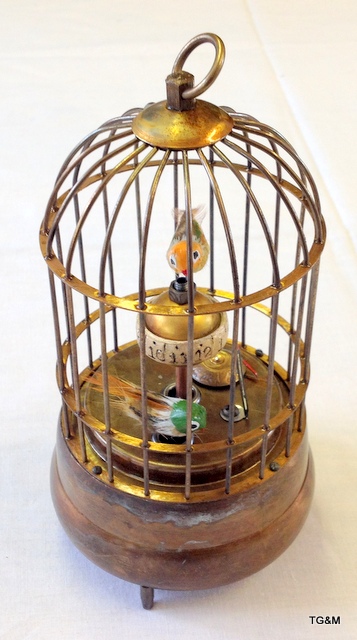 A brass automaton bird cage clock