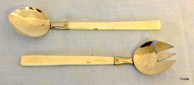 A hand beaten white metal and bone handled spoon and fork