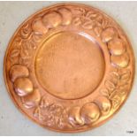 A Newlyn Copper Arts and Crafts plaque depicting fruit 49cm in diameter