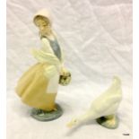 A Nao porcelain figure of a girl holding a basket with another figure of a goose figure 25cm high