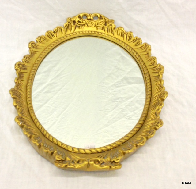 A gilt framed oval wall hanging mirror. 44 x 34cm