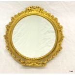 A gilt framed oval wall hanging mirror. 44 x 34cm