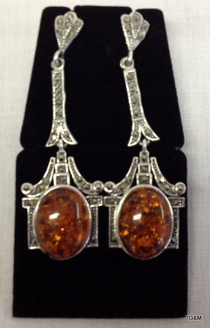 A pair of silver and amber drop earrings