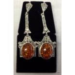 A pair of silver and amber drop earrings