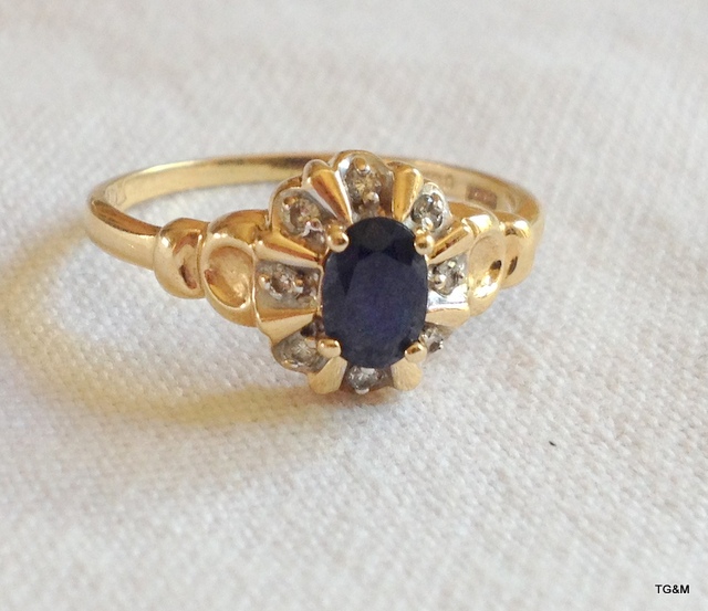 A ladies 9ct gold sapphire and diamond ring. size P