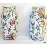 A pair of Victorian pottery vases with flower decoration 26cm high