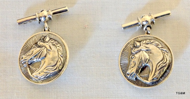 A Pair of Silver Cufflinks depicting Horses