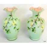 A pair of Victorian glass vases with enamelled flower decoration 19cm high