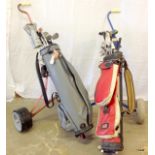 2 sets of golf clubs and 2 golf trolleys