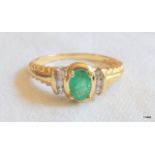 A ladies 9ct gold emerald and diamond ring. size N