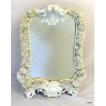 A Meissen Blanc de Sheene mantle / wall mounted mirror with floral and cherub decoration, complete
