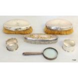 A Hallmarked Silver Magnifying Glass, Two Napkin Rings, Two Brushes and a Lidded Pot