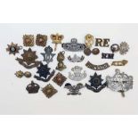 Twenty five military badges etc