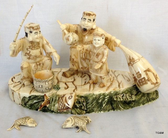 A carved Chinese bone group of fishermen 30cm long