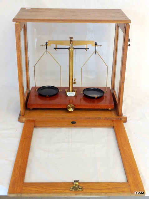 A set of late Victorian precision scales in a light oak glazed case by Eureka - London