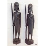 A pair of carved African Tribal Art figures holding spears 44 x 9 x 10