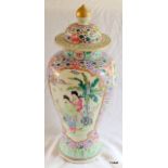 Chinese famille rose jar and cover. Pink ground with panels of figures and birds. 36cm high