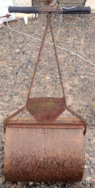 A metal garden roller