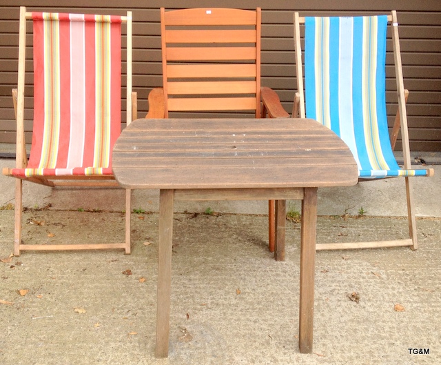 Two vintage deck chairs and a wooden garden table and chair