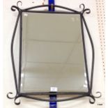 A wrought iron framed mirror
