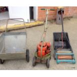 A vintage Hayter lawn mower, a grass barrow and a lawn raker