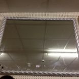 A large wooden silver coloured mirror