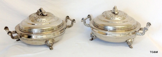 A pair of large silver plated embossed serving dishes