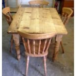 A rustic pine rectangular table and 4 spindle back chairs 77 x 122 x 90